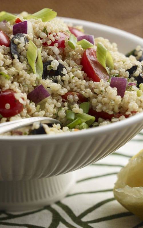 Recipe for Mediterranean Quinoa Salad - What a party of flavor! A tasty side salad featuring quinoa and a colorful variety of vegetables. Feta cheese and a light lemon dressing complete the Mediterranean Quinoa Salad.
