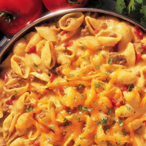 Recipe for Cheesy Picante Beef Macaroni - This one-pot dinner is full of big flavors. Sauteed ground beef is stirred into shell pasta with a cheesy picante sauce to make a delicious hearty family dinner.