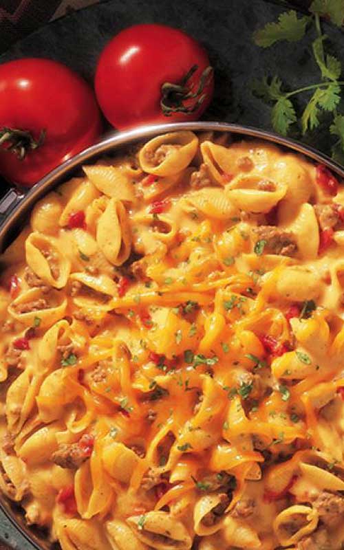 Recipe for Cheesy Picante Beef Macaroni - This one-pot dinner is full of big flavors. Sauteed ground beef is stirred into shell pasta with a cheesy picante sauce to make a delicious hearty family dinner.