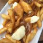 French Fries with Gravy and Cheese Curds - A savory mound of french-fried potatoes topped with beef gravy and fresh cheese curds. This Traditional Canadian Poutine is one the ultimate late-night snacks.