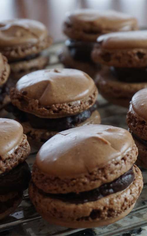 Whip up a batch of these French Chocolate Macarons and pretend that you are taking a trip to Paris. You will fall in love with these crisp chocolate cookies and their luscious creamy ganache filling.